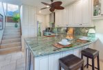 Enjoy a large copper farmhouse sink, custom cabinetry, ceiling fan, and all stainless-steel appliances